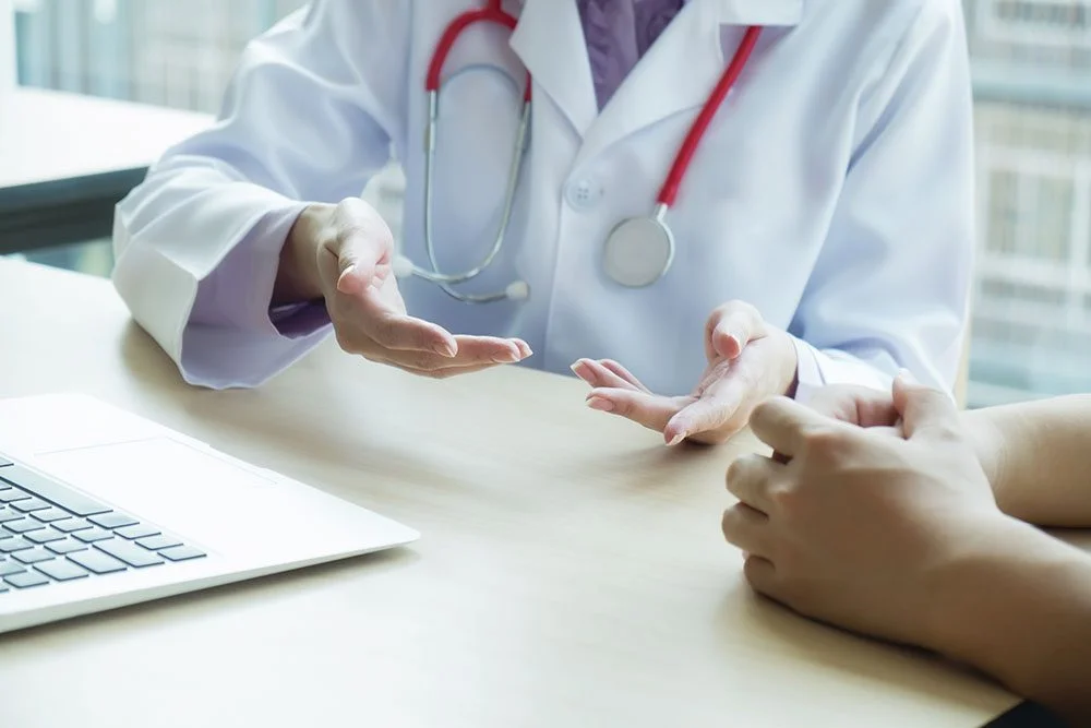 Doctor consulting with patient at desk