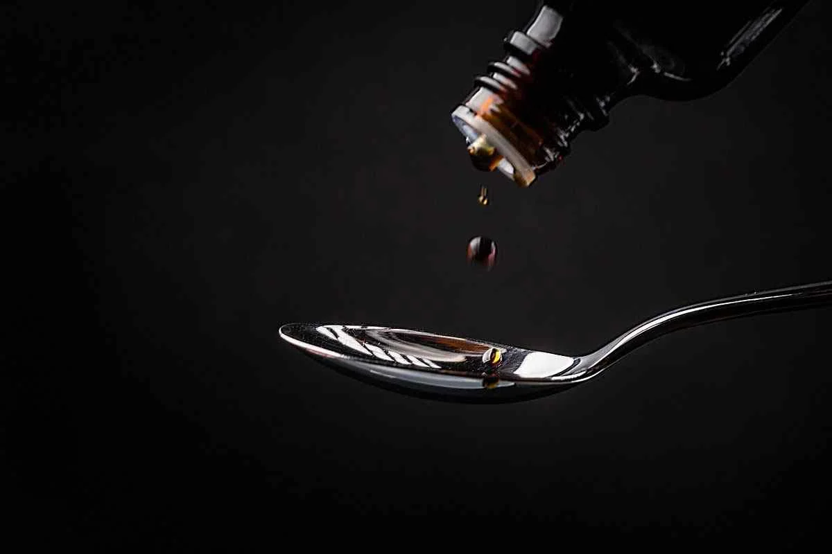 Medicine syrup pouring into spoon