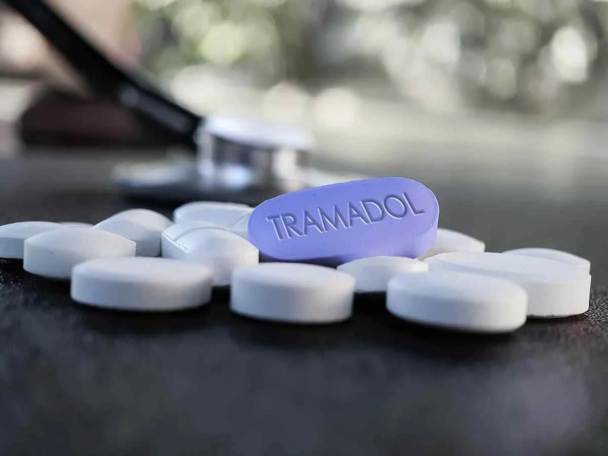 Tramadol pill surrounded by white tablets