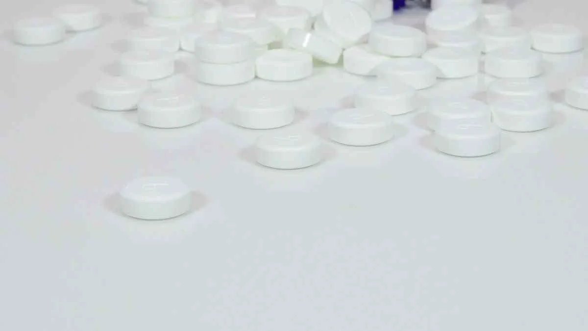 White tablets scattered on surface